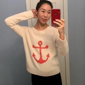 Cute beige knit sweater with a pink fuzzy anchor